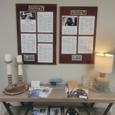 A man standing at a laptop in an office.